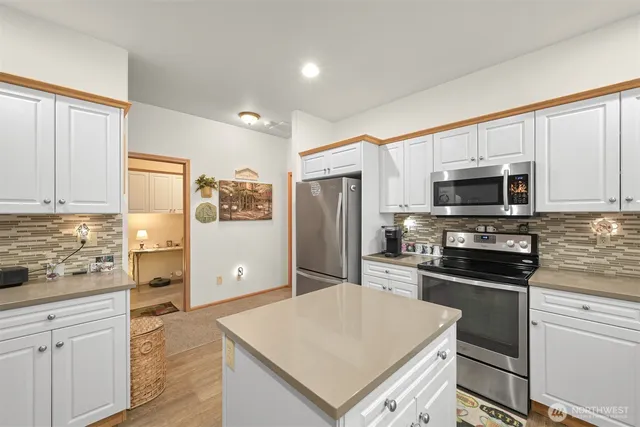a kitchen with a refrigerator stove and microwave
