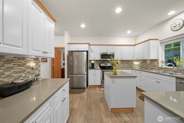 a kitchen with refrigerator and cabinets