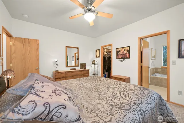 a bedroom with a large bed and a chandelier