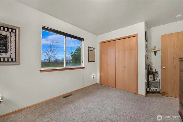 an empty room with windows and closet