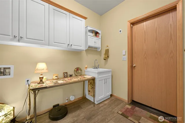 a room with a sink and cabinets