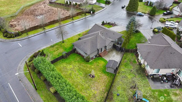 an aerial view of a house with a garden and a yard