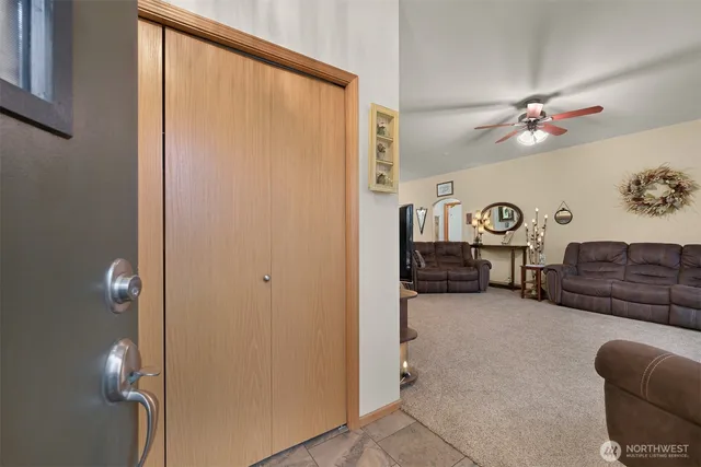 a view of a livingroom with furniture and a ceiling fan