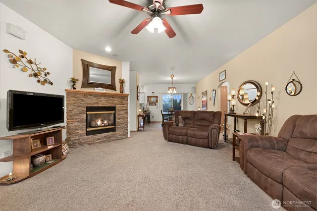 a living room with furniture a flat screen tv and a fireplace