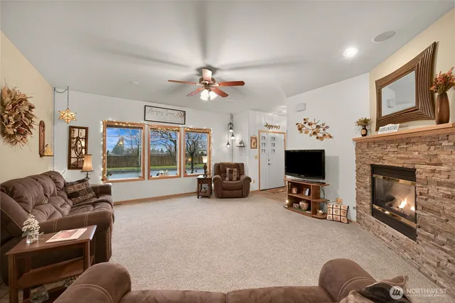 a living room with furniture a fireplace and a flat screen tv