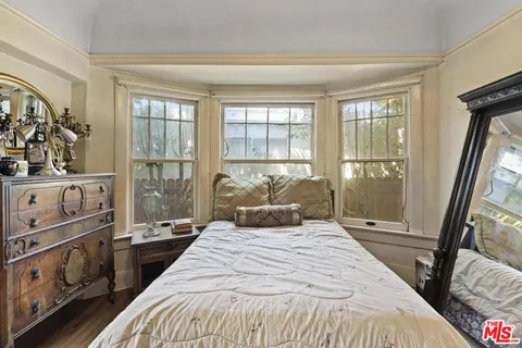 a bedroom with a large bed and a window