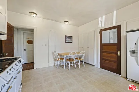 a large white kitchen with cabinets and furniture