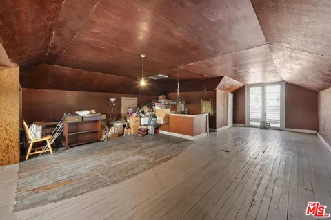 a view of a room with wooden floor and windows