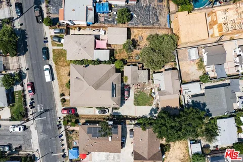 an aerial view of residential houses with city view