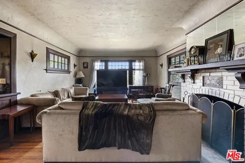 a living room with fireplace furniture and a flat screen tv