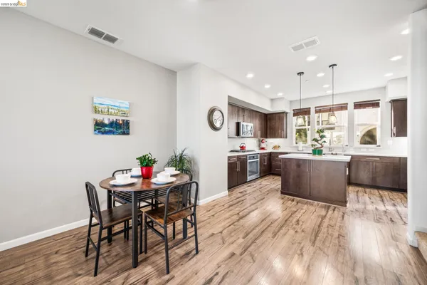 a large kitchen with a table and chairs