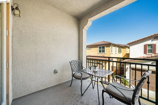 a view of a balcony with chairs