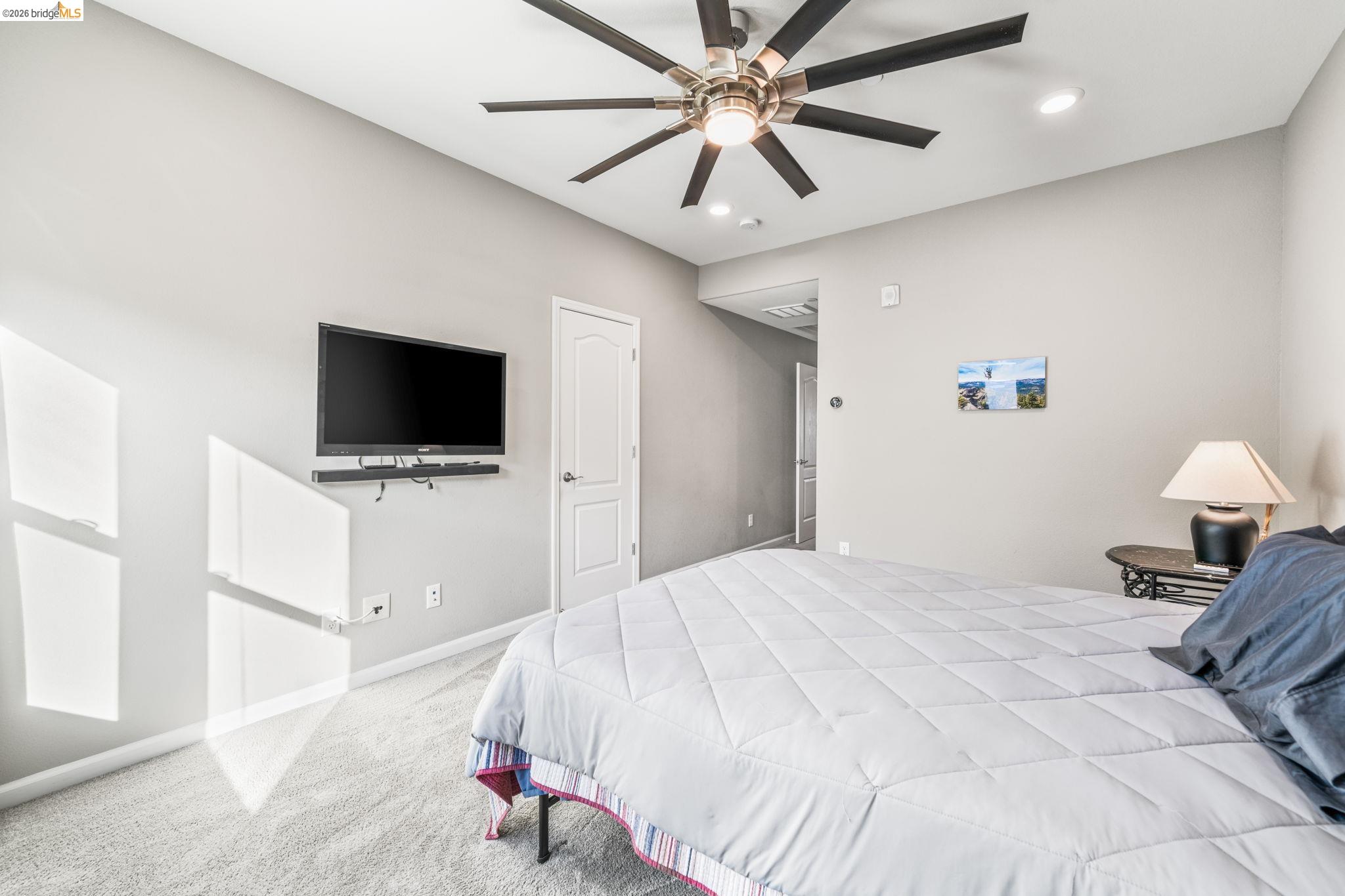 1280 Gusty Loop, Unit 4 Livermore, CA 94550 - Photo 16 of 40 a bedroom with a bed and a flat screen tv