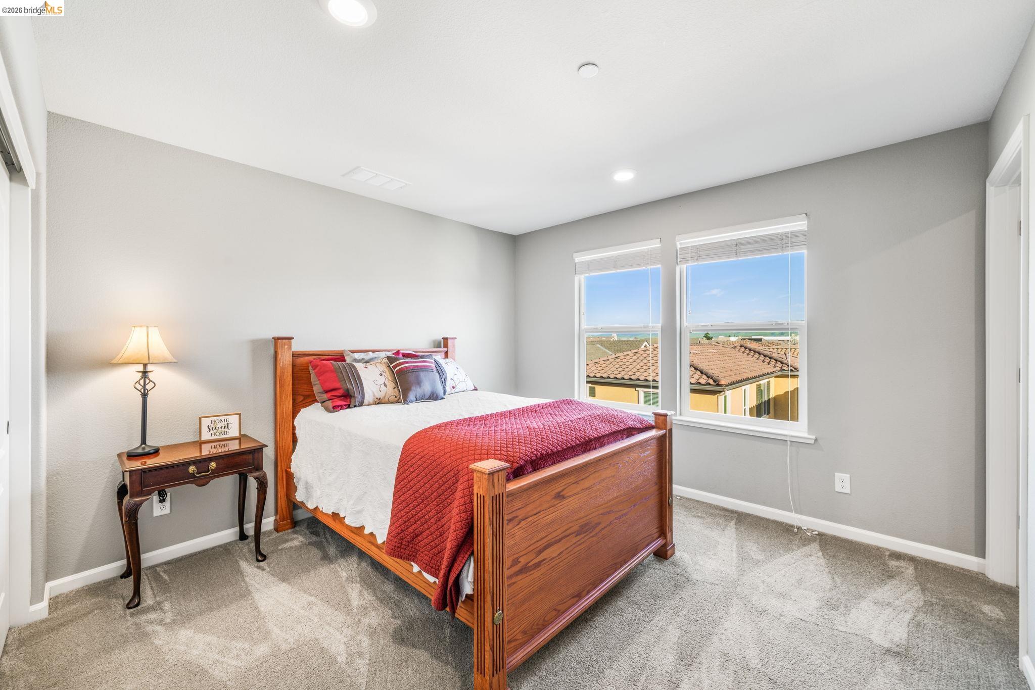 1280 Gusty Loop, Unit 4 Livermore, CA 94550 - Photo 18 of 40 a spacious bedroom with a bed and a window