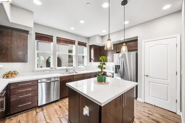 a kitchen with a stove a refrigerator and a sink