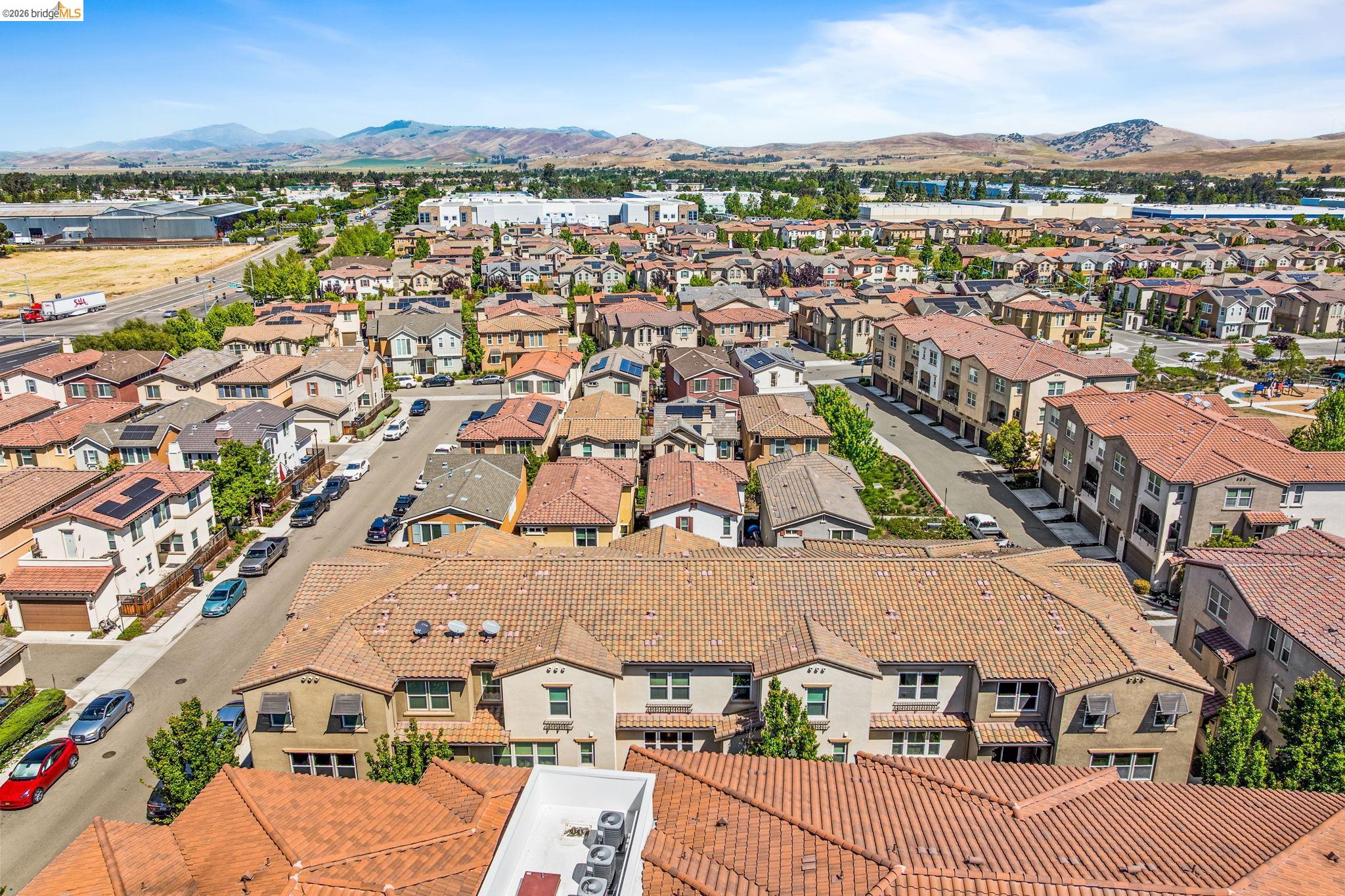 1280 Gusty Loop, Unit 4 Livermore, CA 94550 - Photo 33 of 40 an aerial view of a city with lots of residential buildings and mountain view in back
