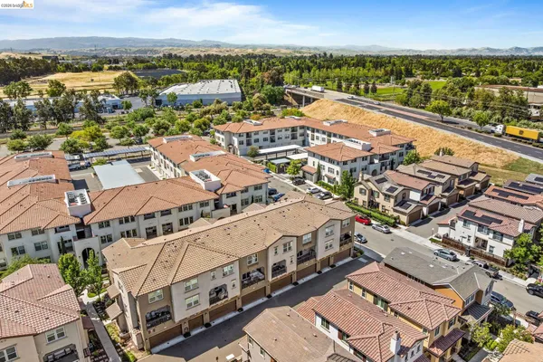 an aerial view of residential houses with outdoor space