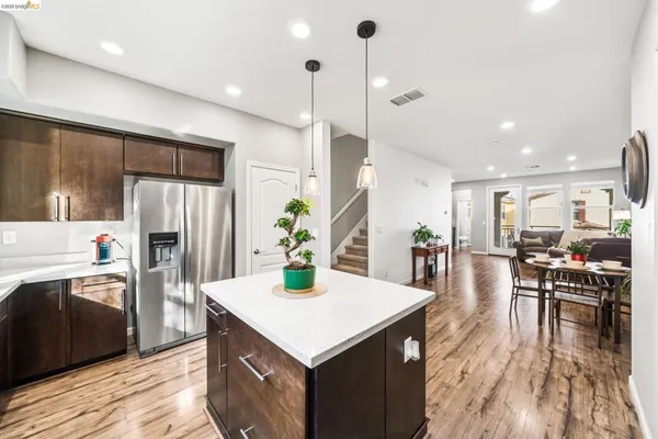 a kitchen with a table chairs refrigerator and microwave