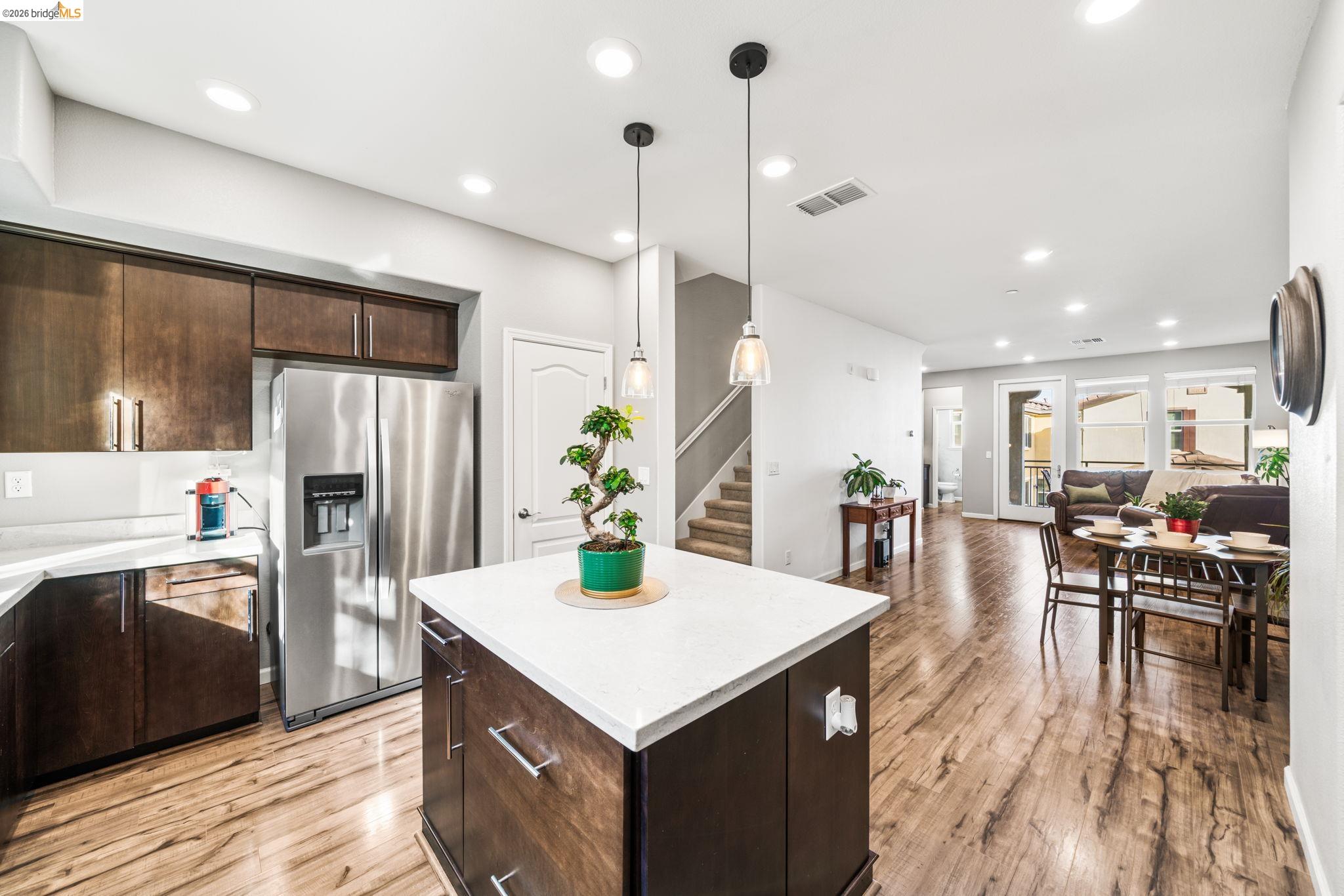 1280 Gusty Loop, Unit 4 Livermore, CA 94550 - Photo 5 of 40 a kitchen with a table chairs refrigerator and microwave