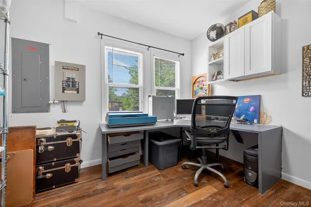 a view of a workspace with furniture and a window