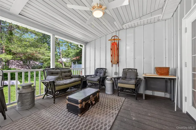a living room with patio furniture and a fireplace