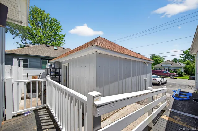a view of backyard with deck and outdoor seating