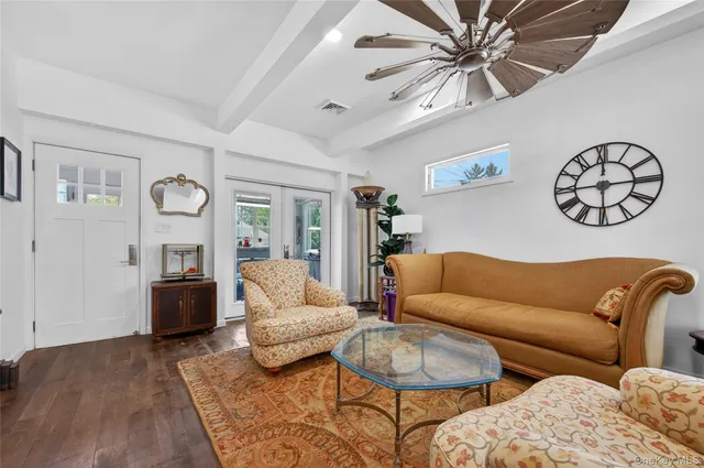 a living room with furniture ceiling fan and a rug