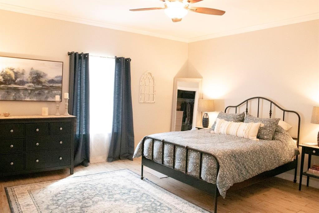 298 Redbud A Mexia, TX 76667 - Photo 15 of 40 a bedroom with a bed a window and painting on the wall