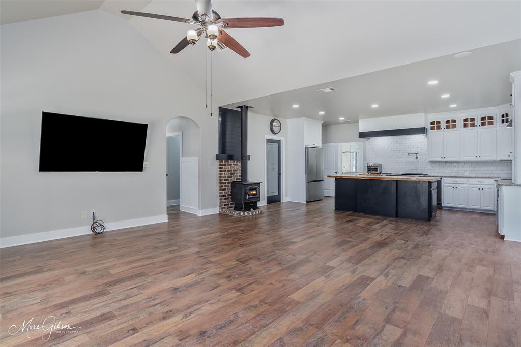 550 Linton Bellevue Road Benton, LA 71006 - Photo 37 of 37 Kitchen featuring open floor plan, a center island, tasteful backsplash, glass insert cabinets, and high vaulted ceiling