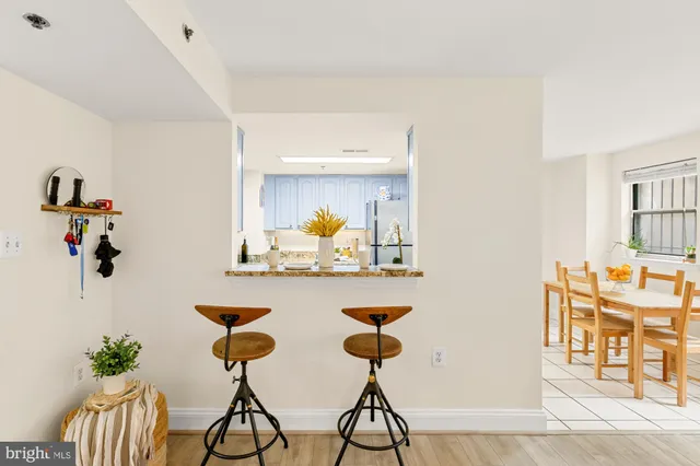 a kitchen with stainless steel appliances granite countertop a refrigerator a stove a sink and a microwave