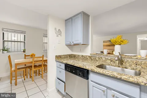 a view of a hallway with wooden floor and closet area