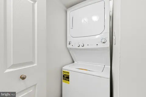 a spacious bedroom with a bed and a lamp