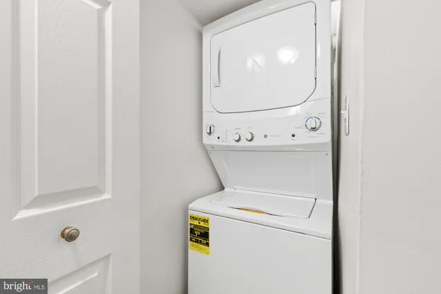 a spacious bedroom with a bed and a lamp