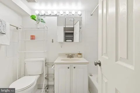 a bathroom with a sink a toilet and bathtub