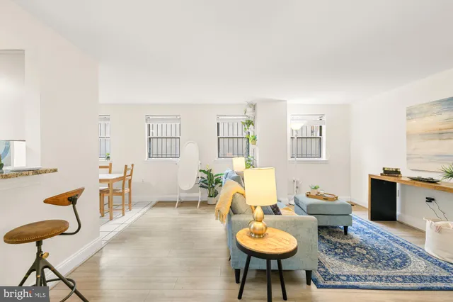 a living room with furniture and wooden floor