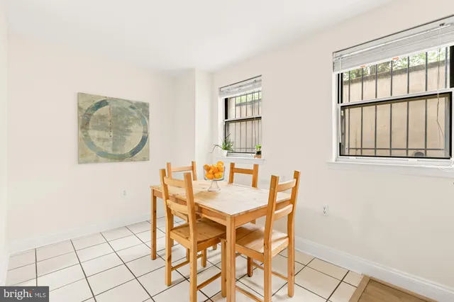 a dining room with furniture and wooden floor