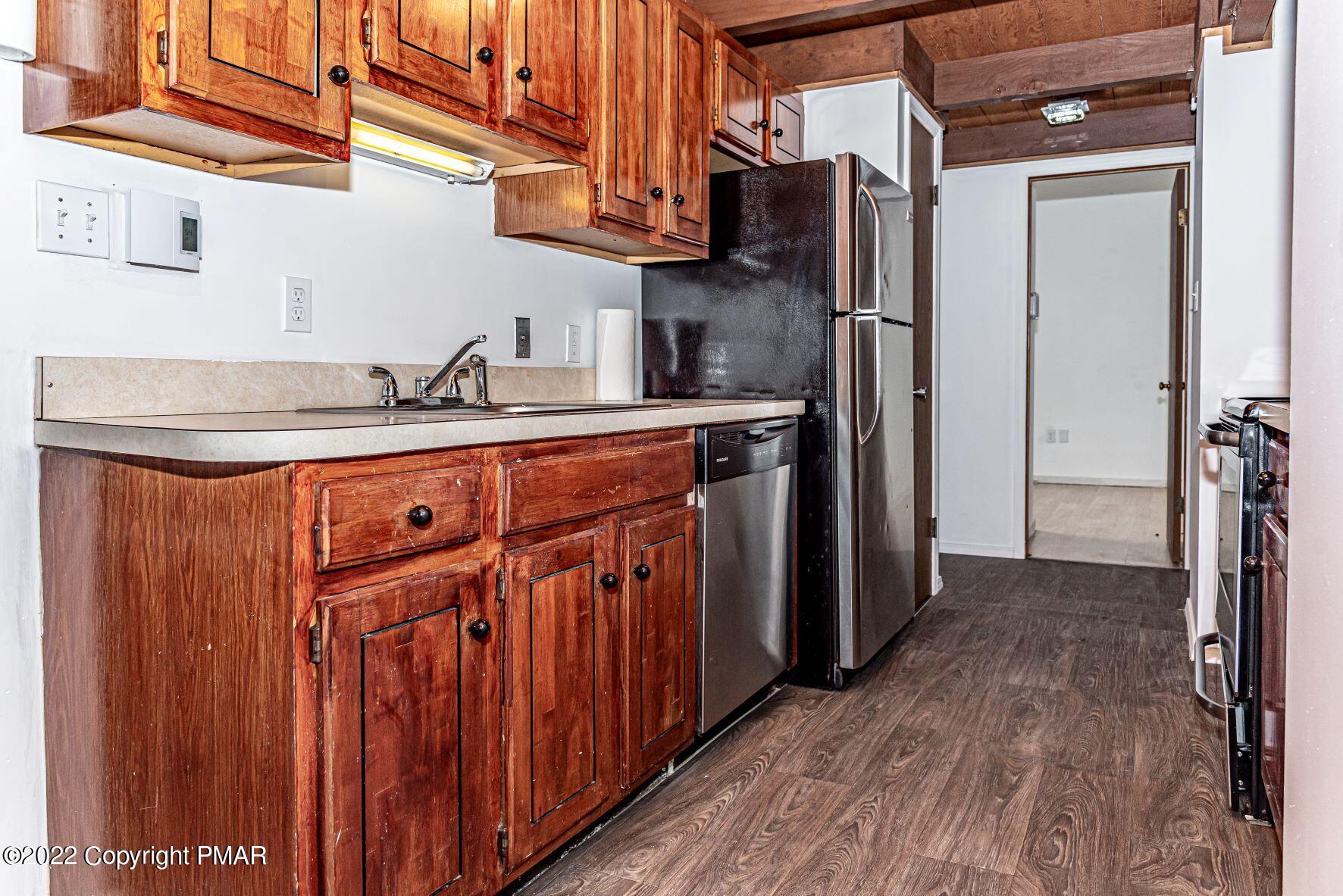 250 Canterbury Road Bushkill, PA 18324 - Photo 14 of 39 a kitchen with stainless steel appliances granite countertop a refrigerator and a sink