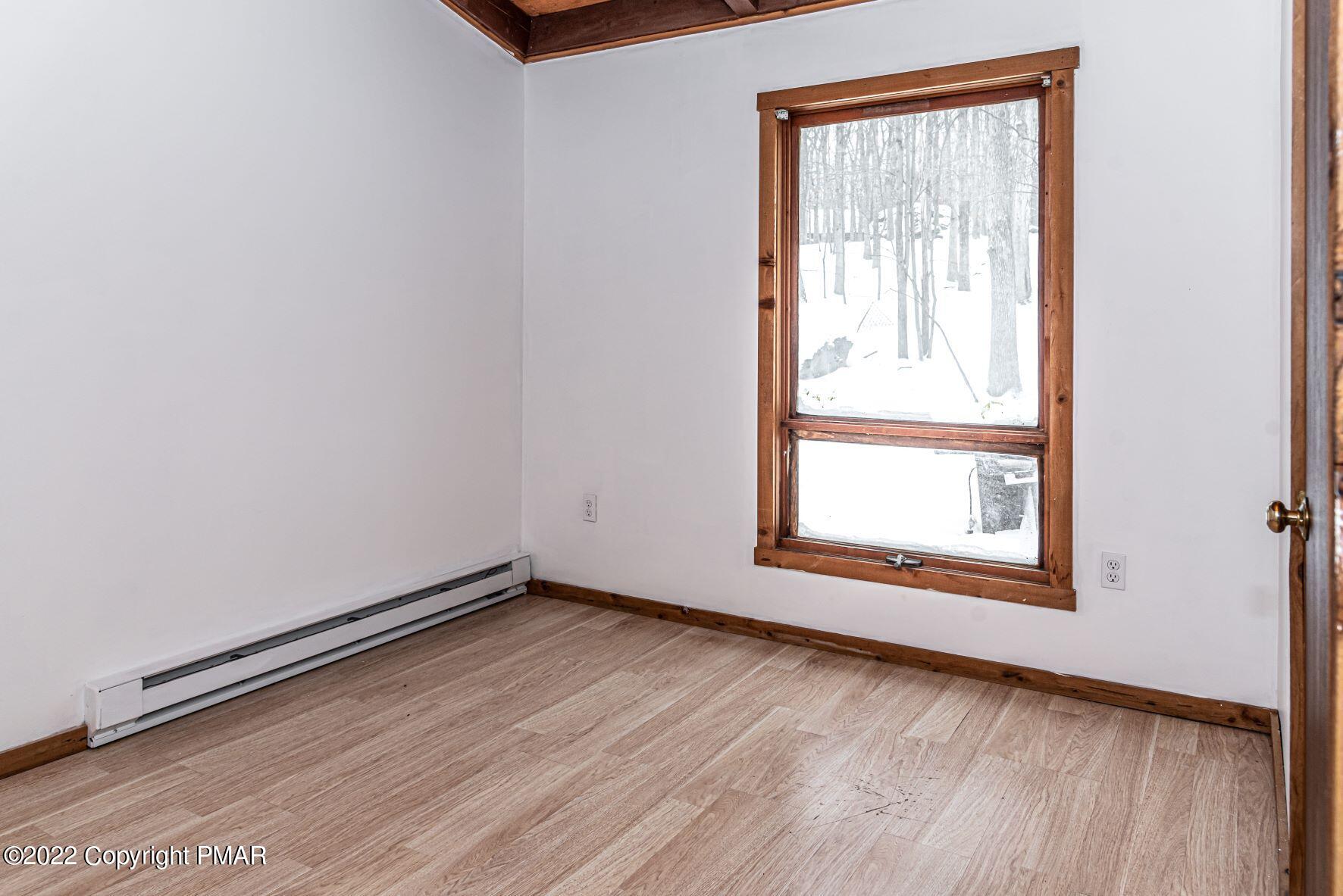 250 Canterbury Road Bushkill, PA 18324 - Photo 25 of 39 a view of an empty room with wooden floor and a window