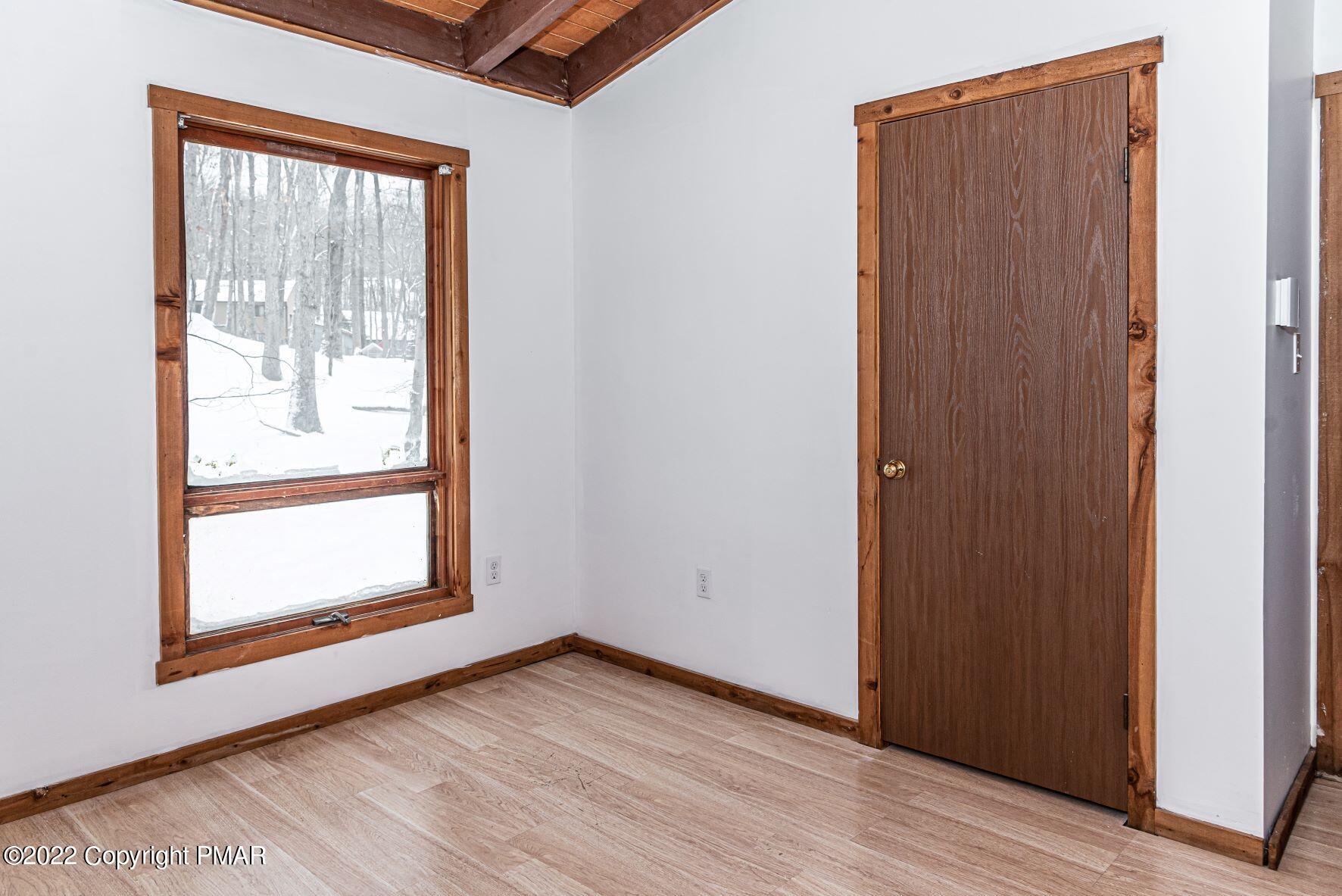 250 Canterbury Road Bushkill, PA 18324 - Photo 27 of 39 an empty room with wooden floor and windows