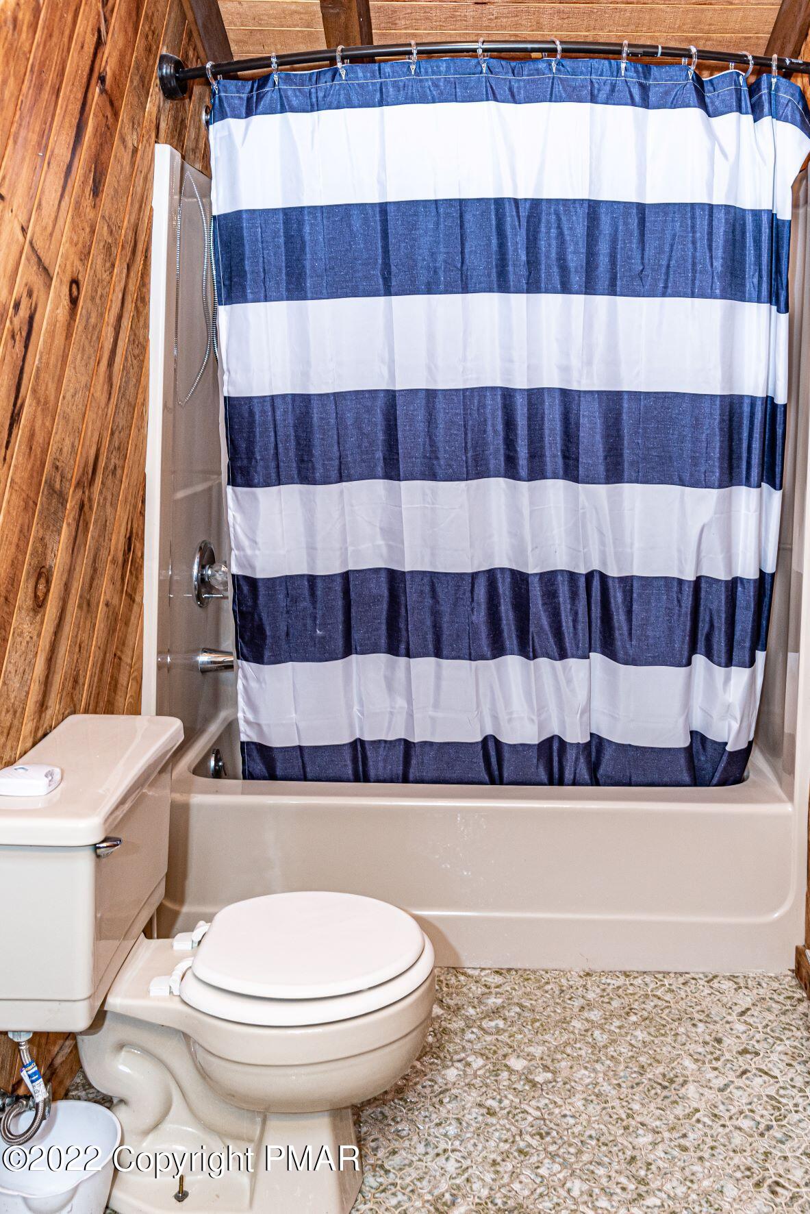250 Canterbury Road Bushkill, PA 18324 - Photo 35 of 39 a bathroom with a toilet and a shower curtain