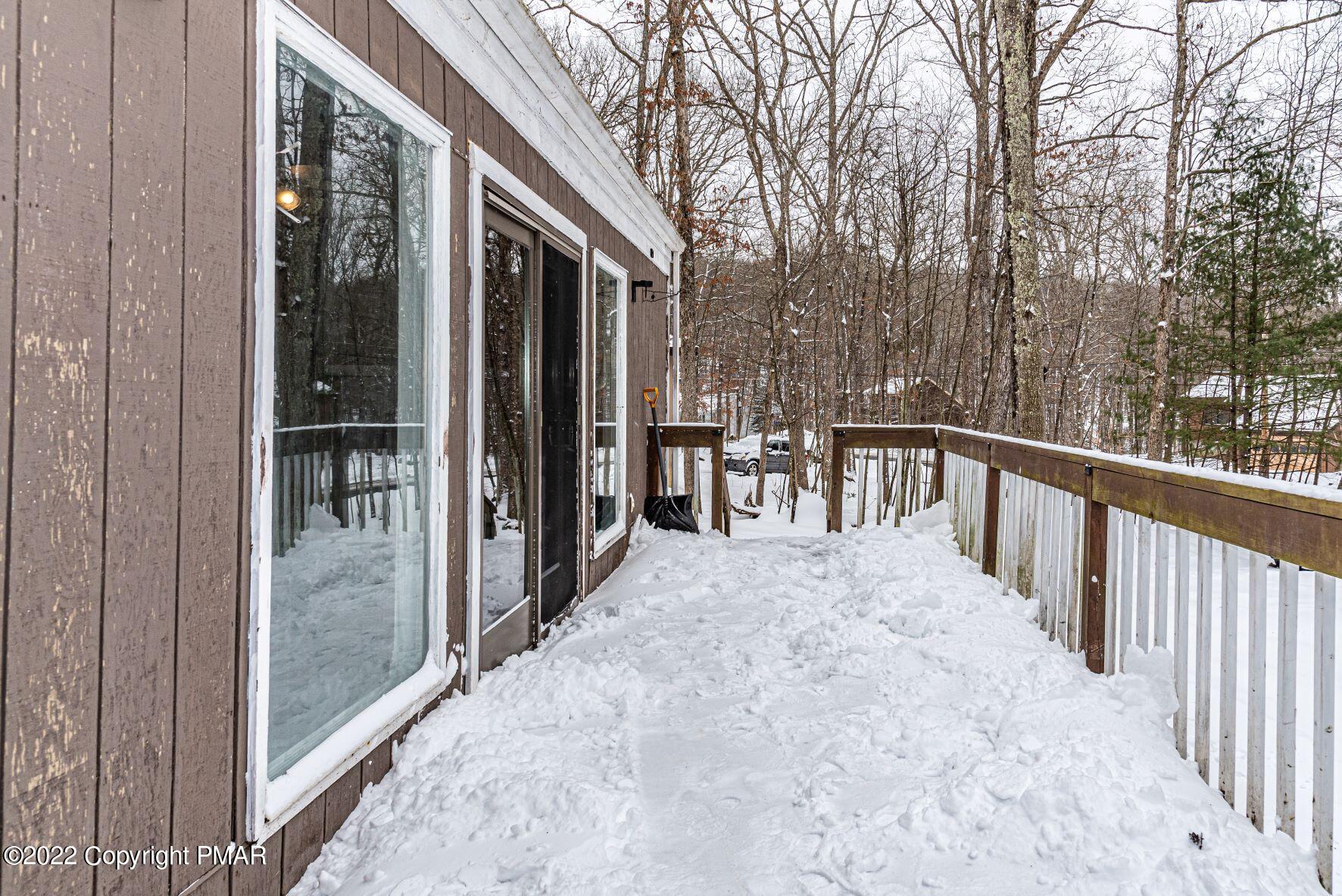 250 Canterbury Road Bushkill, PA 18324 - Photo 8 of 39 a view of a porch with wooden floor and fence