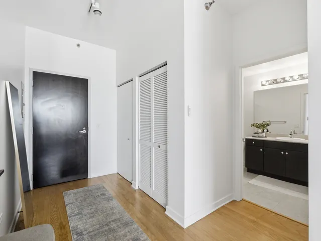 a spacious bathroom with a granite countertop sink and a mirror