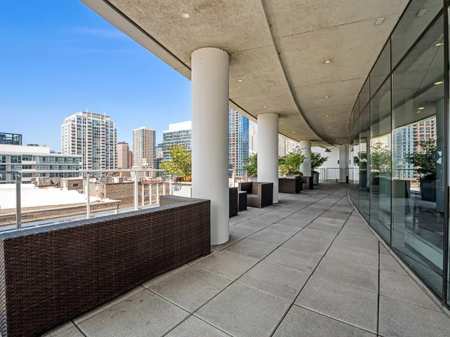 a view of a patio with table and chairs and potted plants