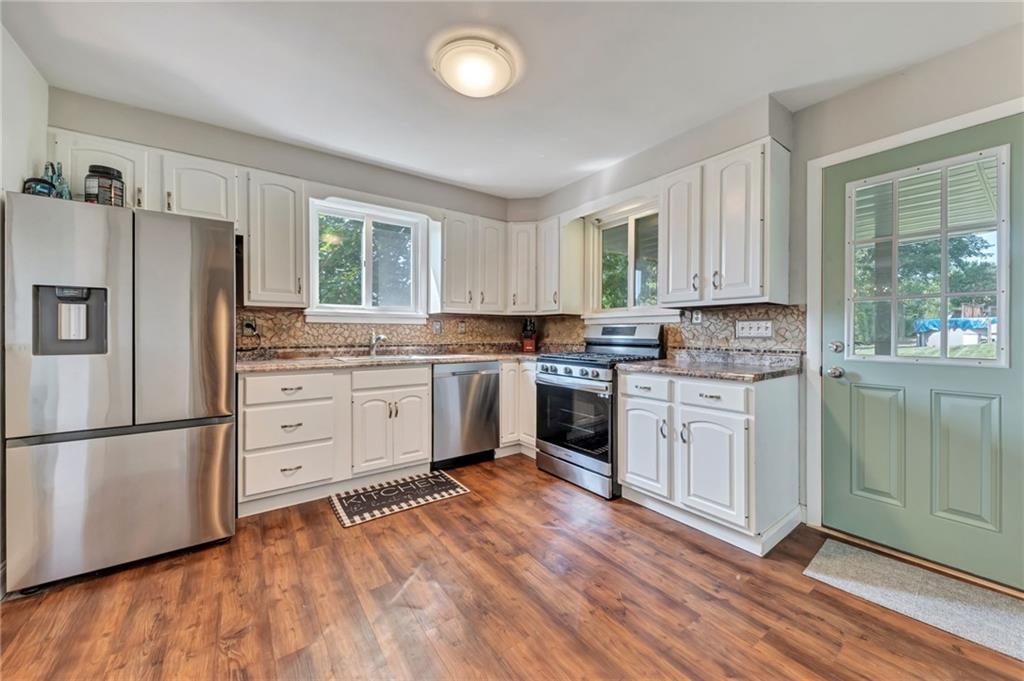 40 Greenview Drive McKees Rocks, PA 15136 - Photo 12 of 42 a kitchen with granite countertop white cabinets and white stainless steel appliances