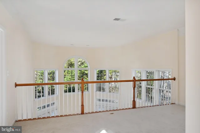 an empty room with windows and entrance