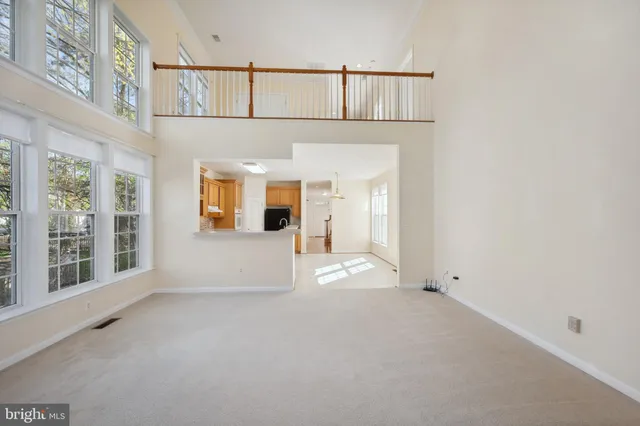 a bathroom with a tub a sink double vanity and a window