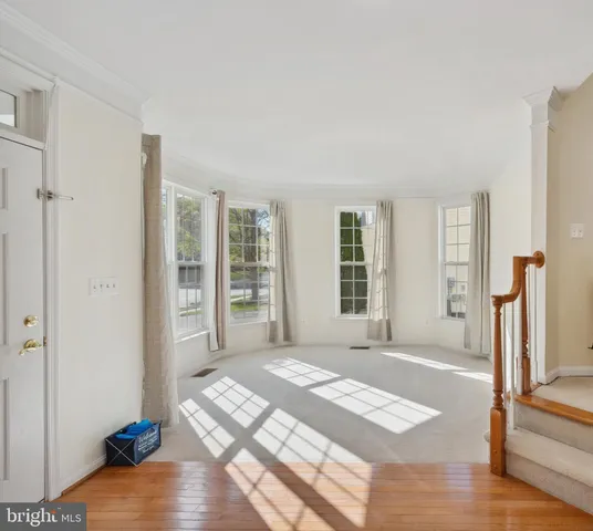a spacious bedroom with a bed and wooden floor