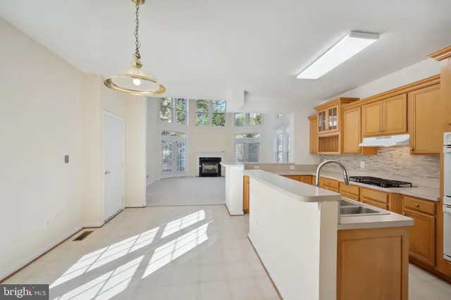 a large kitchen with a sink stove and refrigerator