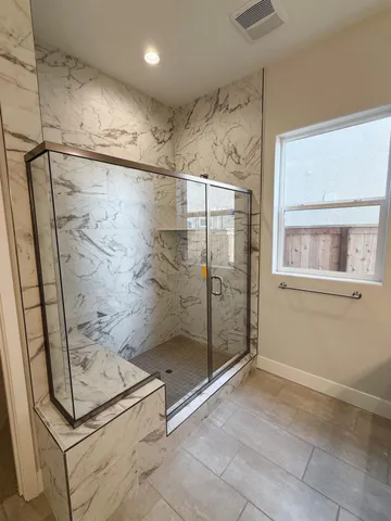 a bathroom with a bathtub and shower
