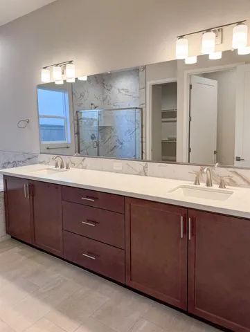 a bathroom with a sink double vanity and a mirror